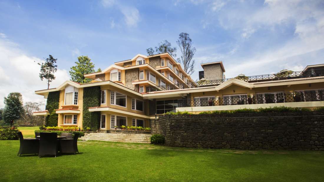 Exterior view of The Carlton featuring a lush garden and sitting area