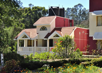 Exterior view of Green Acres Resort surrounded by lush greenery