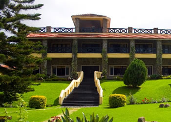 Exterior view of Hill Country Resorts featuring a scenic garden and inviting steps